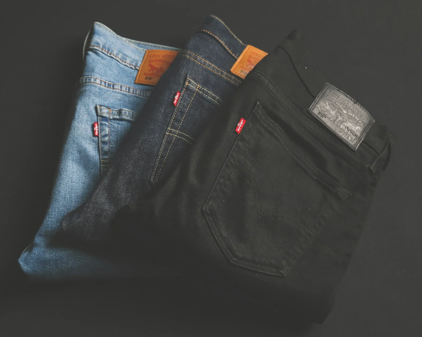 Folded blue and black denim jeans.