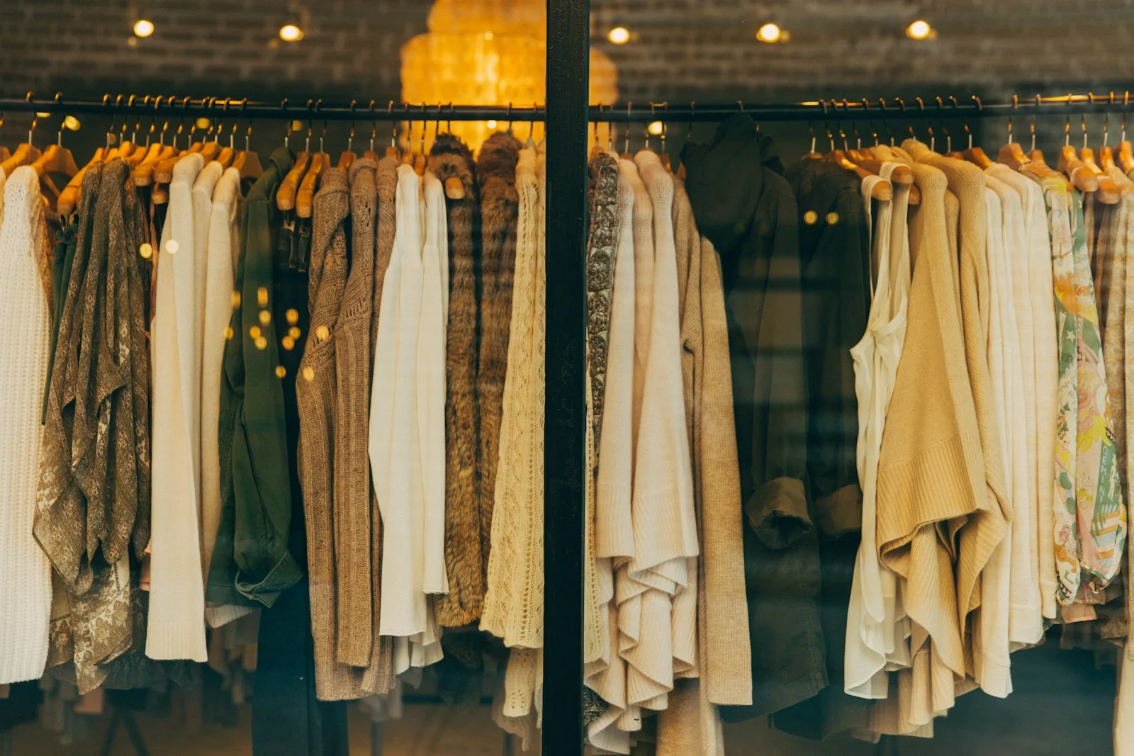 Clothes arranged on rails inside a shop.