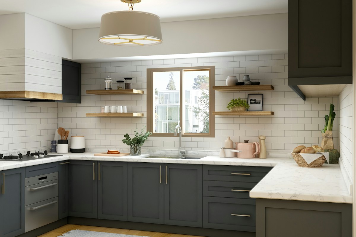 A kitchen with pale upper cupboards, dark lower cupboards and a light worktop.