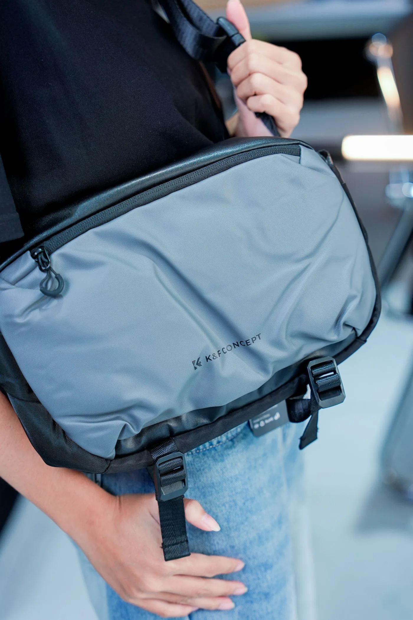 A close view of a grey bag with straps and zips
