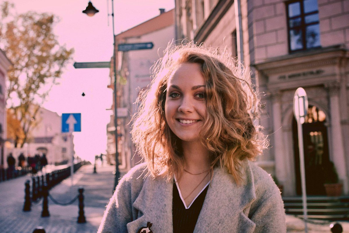 Woman wearing a coat and layered clothing outdoors