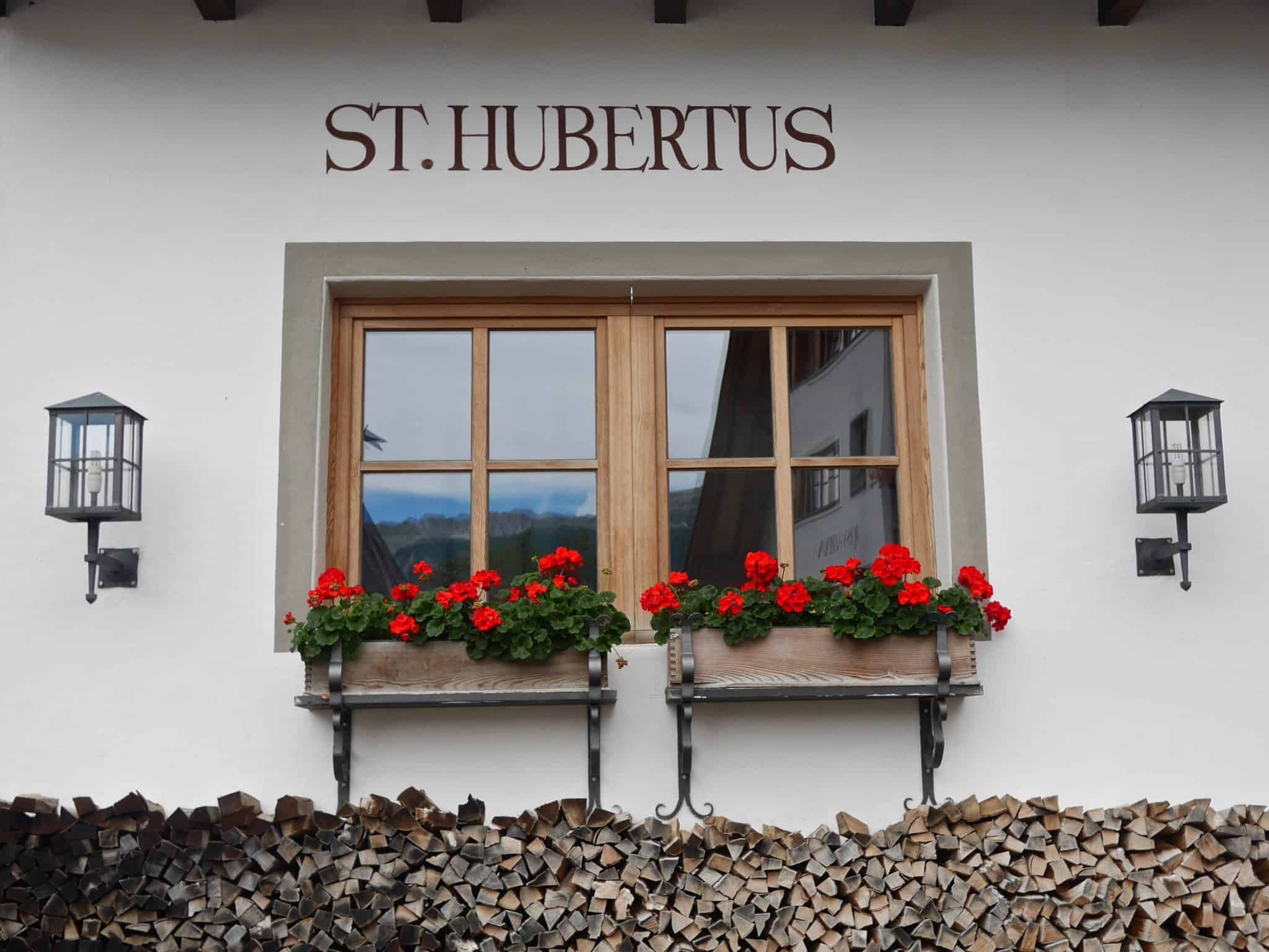 view of the outside of the st Hubertus with red flowers on the window sills