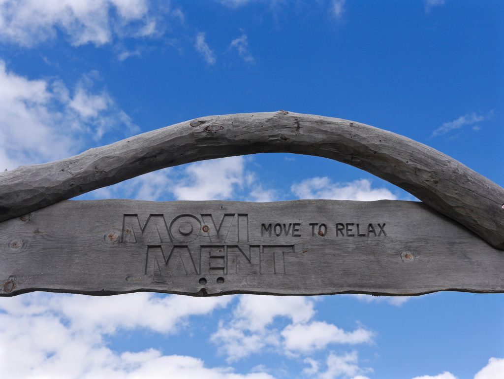 view of a wooden sign engraved with 'movi ment - move to relax'