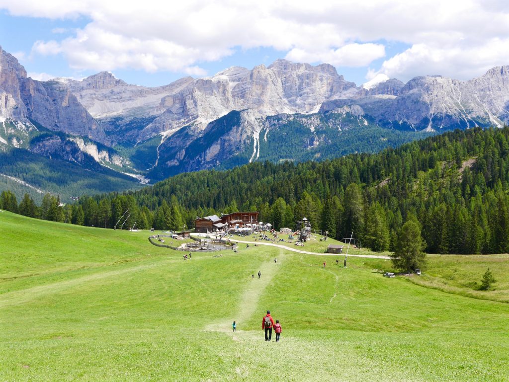 view down in the valley of people walking on the greenery