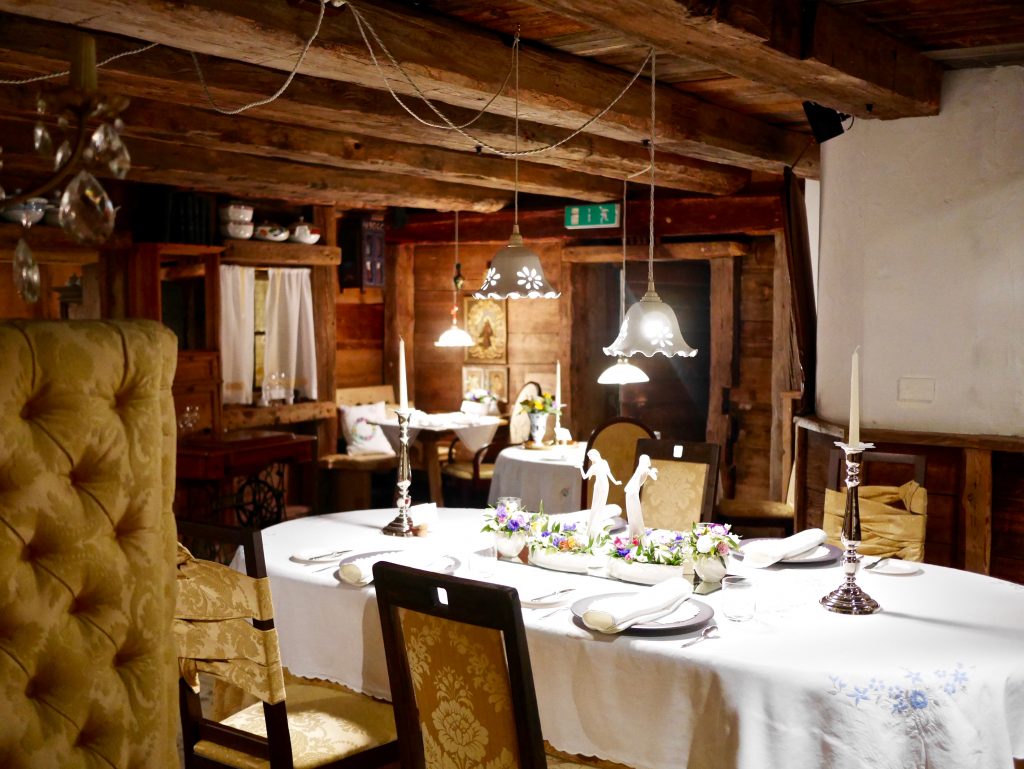 Inside the low ceiling wooden beamed La Stüa de Michil at La Perla restaurant