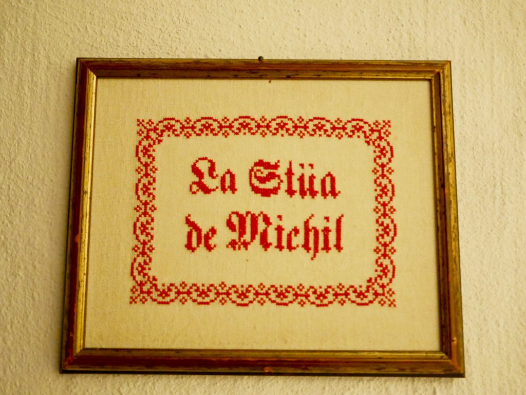 sewed sign on the wall of the La Stüa de Michil at La Perla