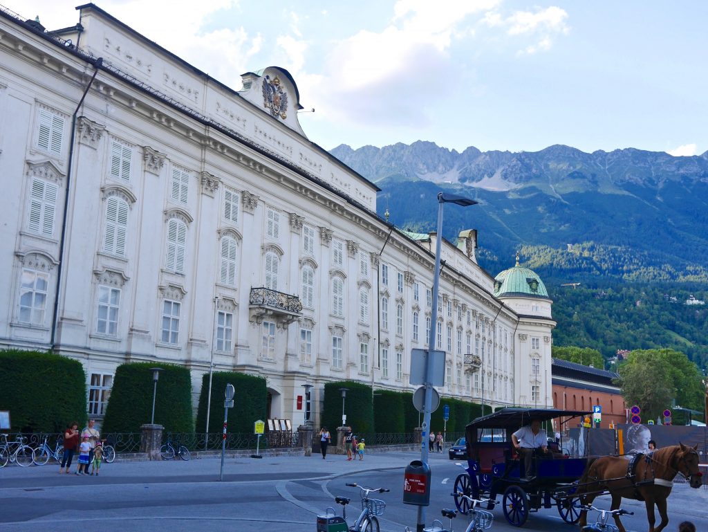 view of the white Hofburg palace with green topped turrets