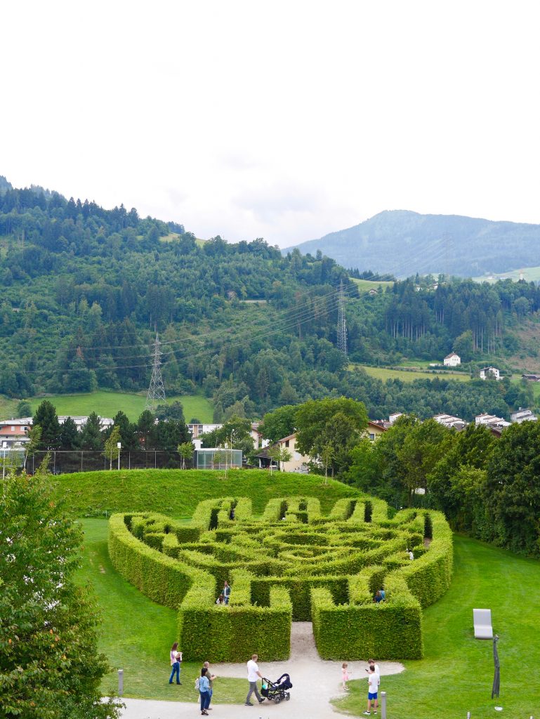 Swarovski Crystal World gardens and hand shaped maze viewed from the tall play tower