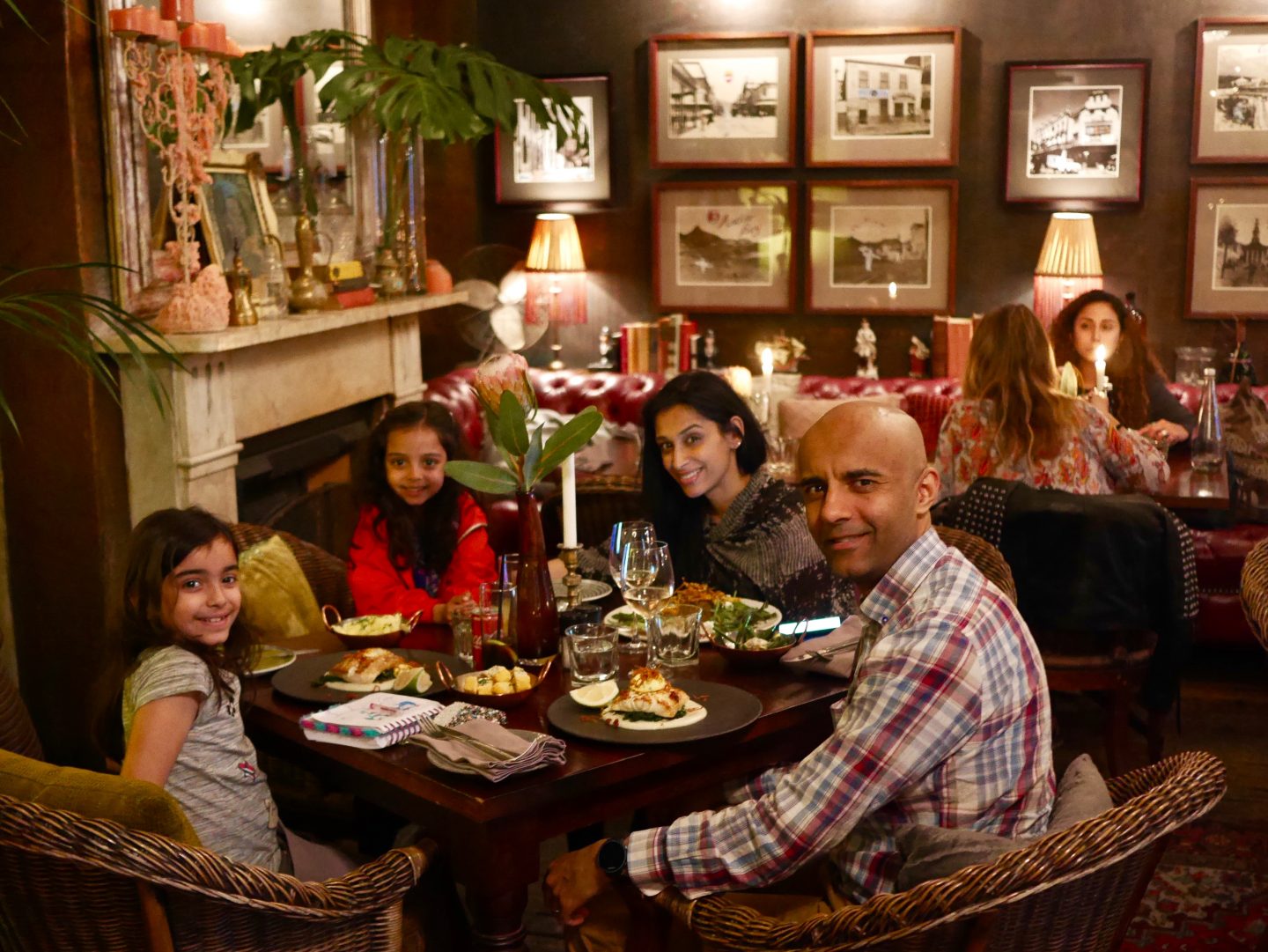 family sat at a table eating in Kloof Street House