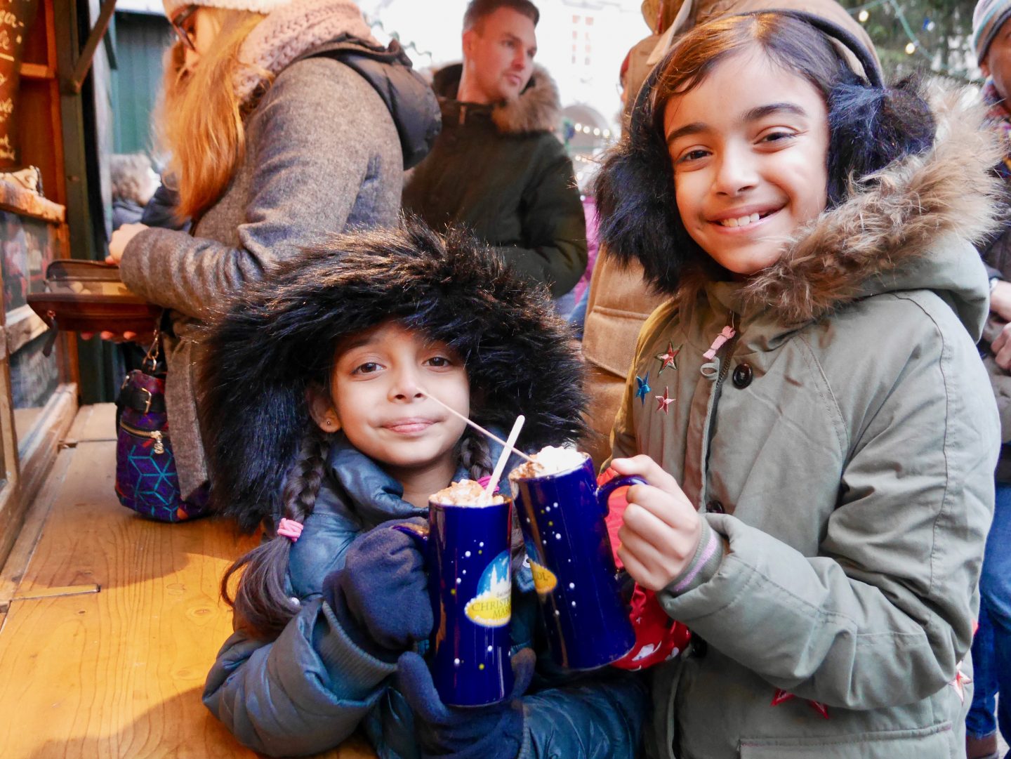 children saying cheers with blue mugs