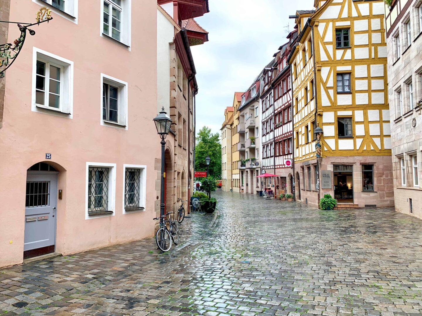 cobbled streets of nuremberg with multicoloured buildings and bicycles against street lamp