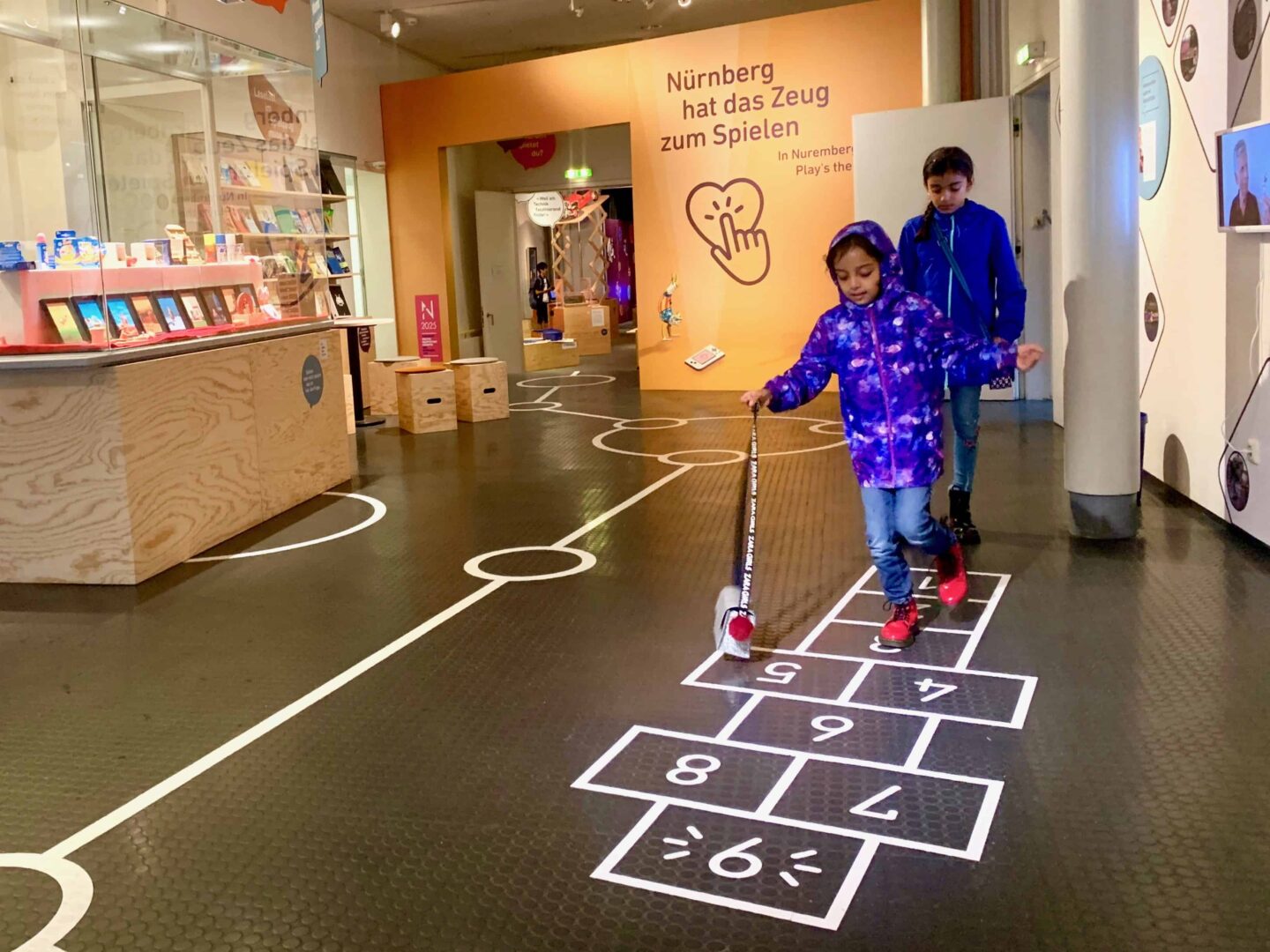 two girls playing hopscotch in the Toy Museum (Spielzeugmuseum) | Germany with kids
