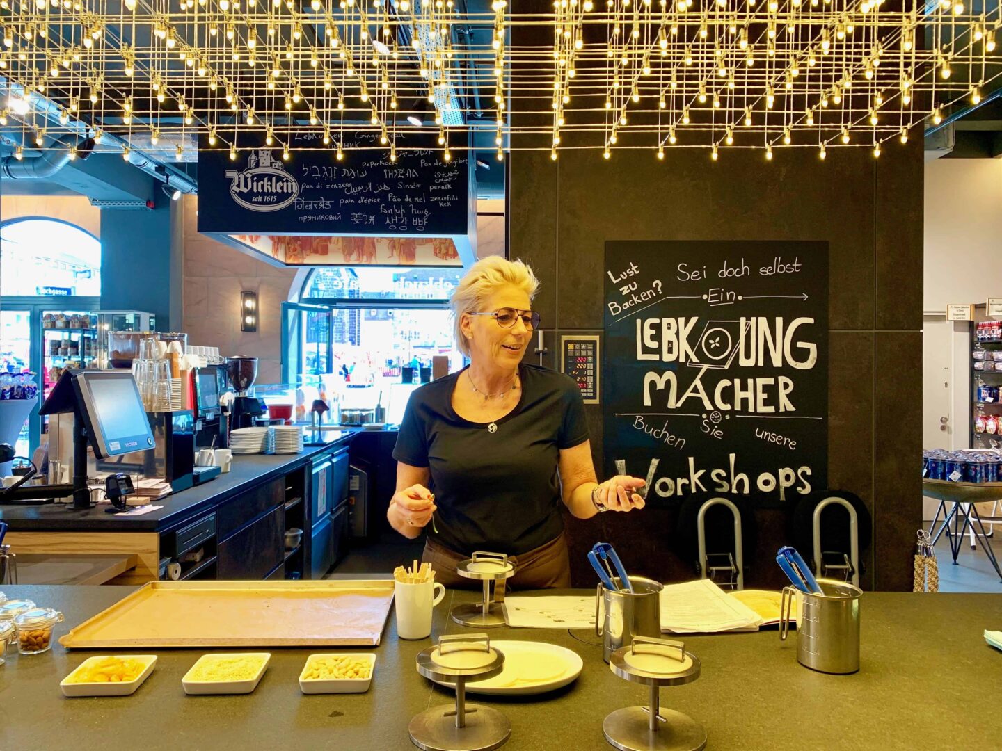 teacher of workshop behind counter with ingredients and tools