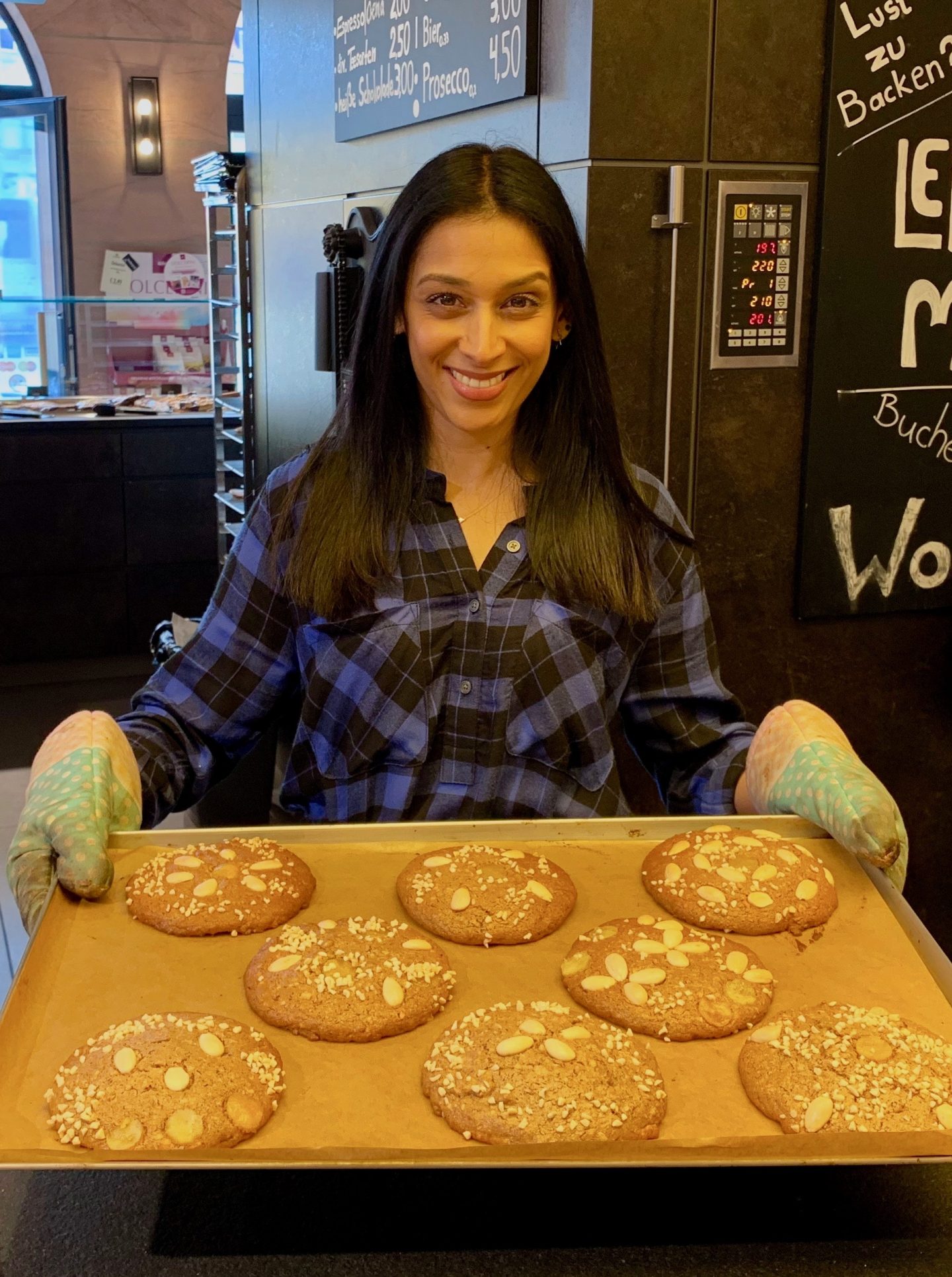 lady holding tray of baked Lebkuchen with almonds