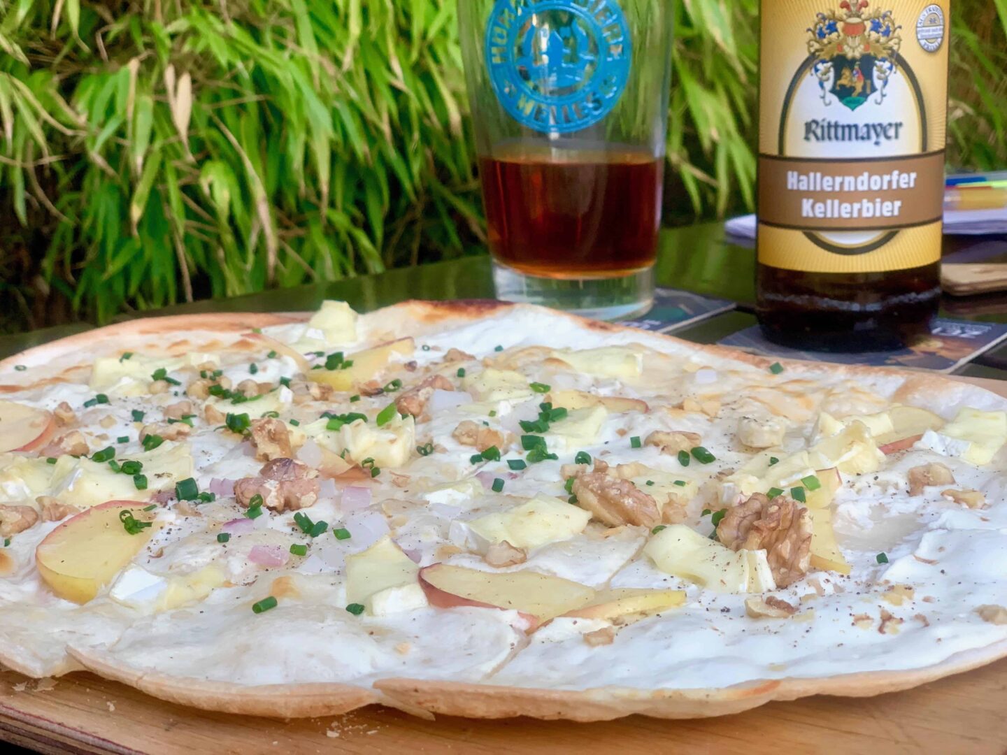 Flammkuchen, a thin flatbread and Germany's version of a thin crispy pizza. With toppings; sour cream, bacon and onions