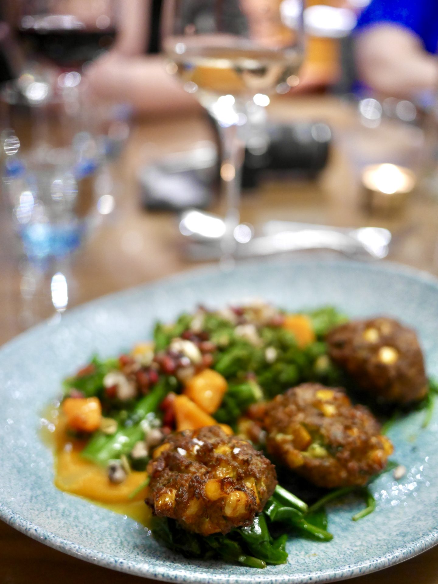 courgette and sweetcorn fritters accompanied with butternut squash, tenderstem broccoli, topped with pomegranate, toasted seeds and maple dressing.