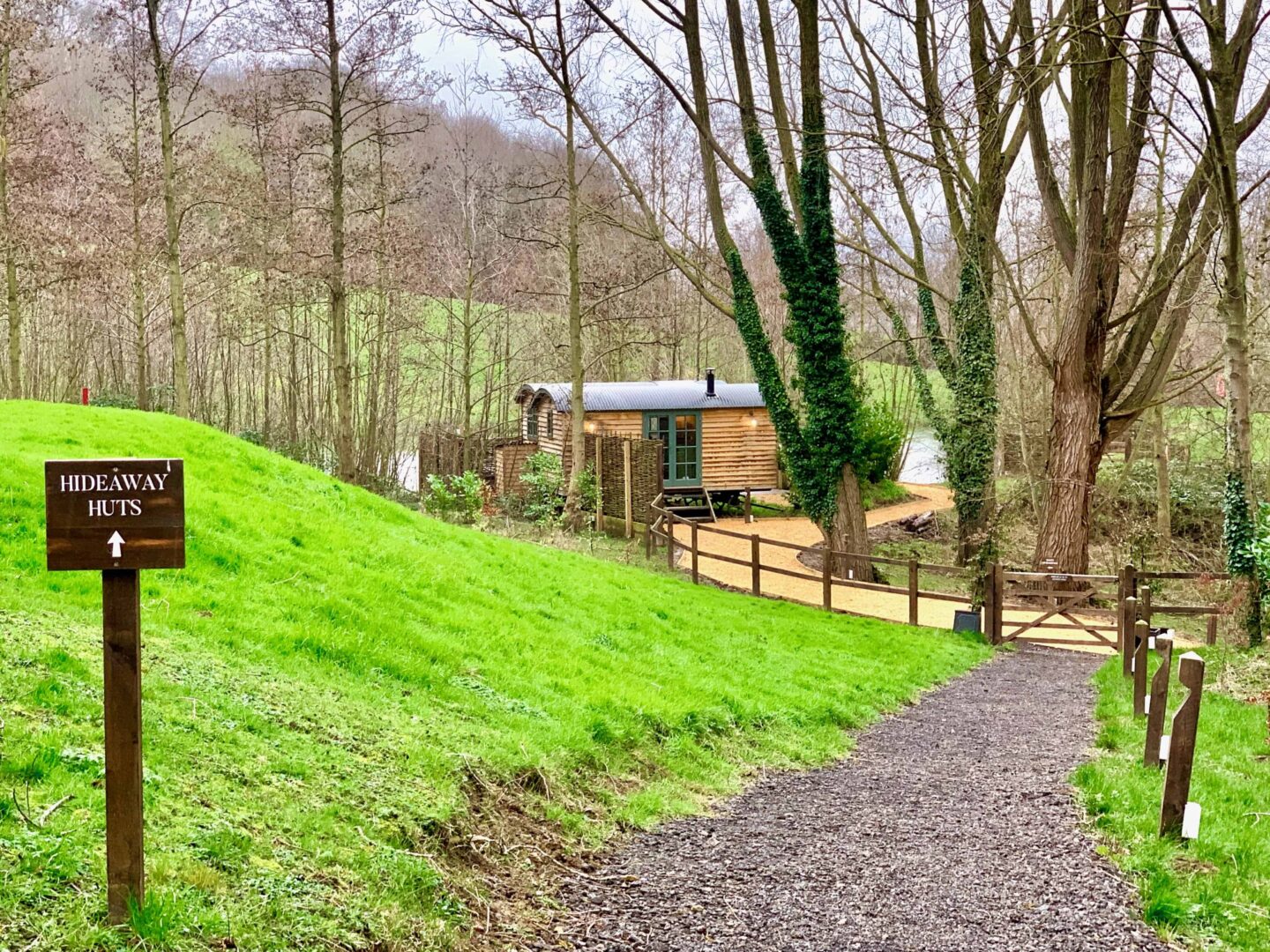 image looking down a hill towards the hideaway huts at the fish hotel in the cotswolds