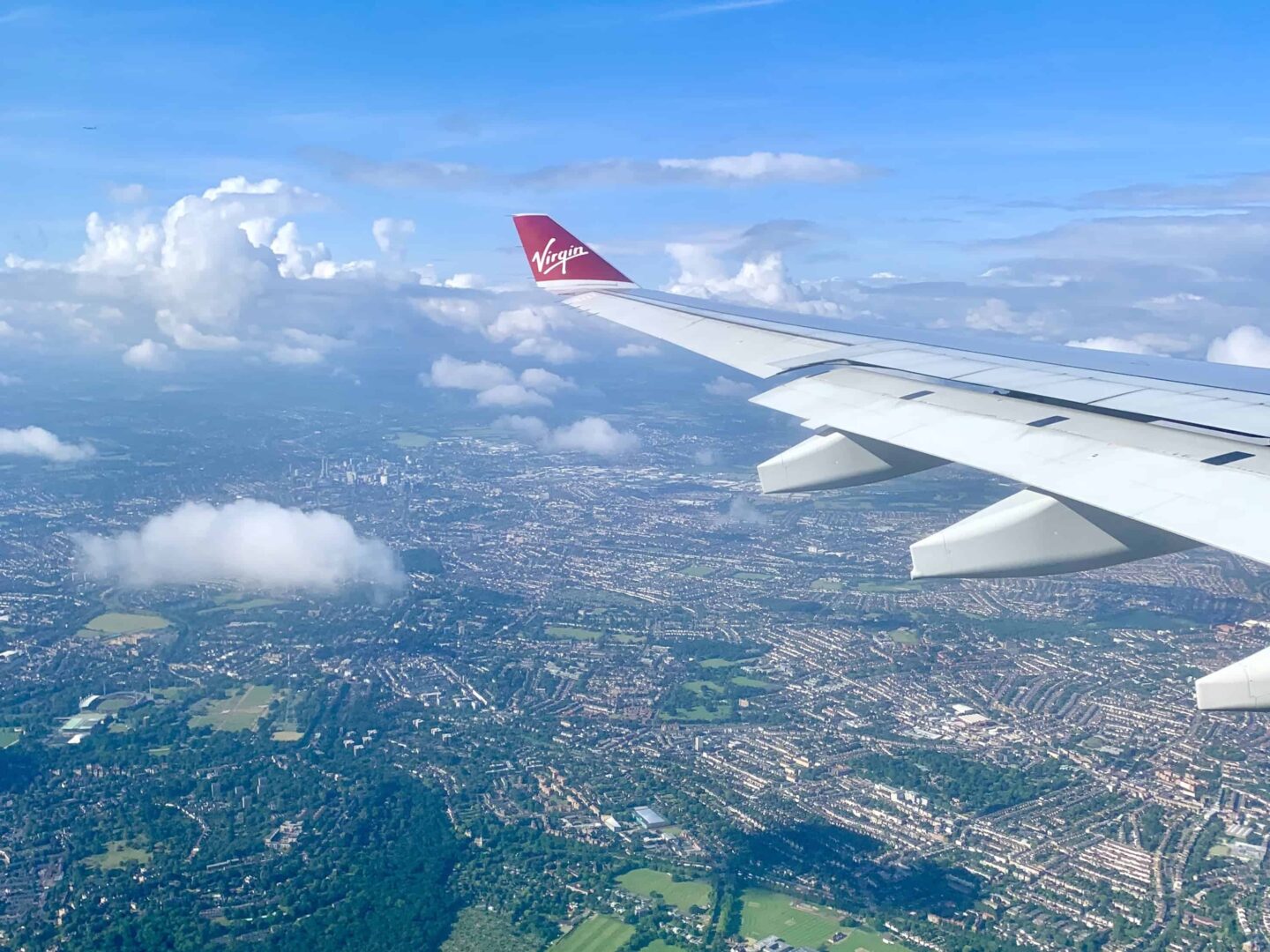 view over UK looking over the wing of a virgin Atlantic flight
