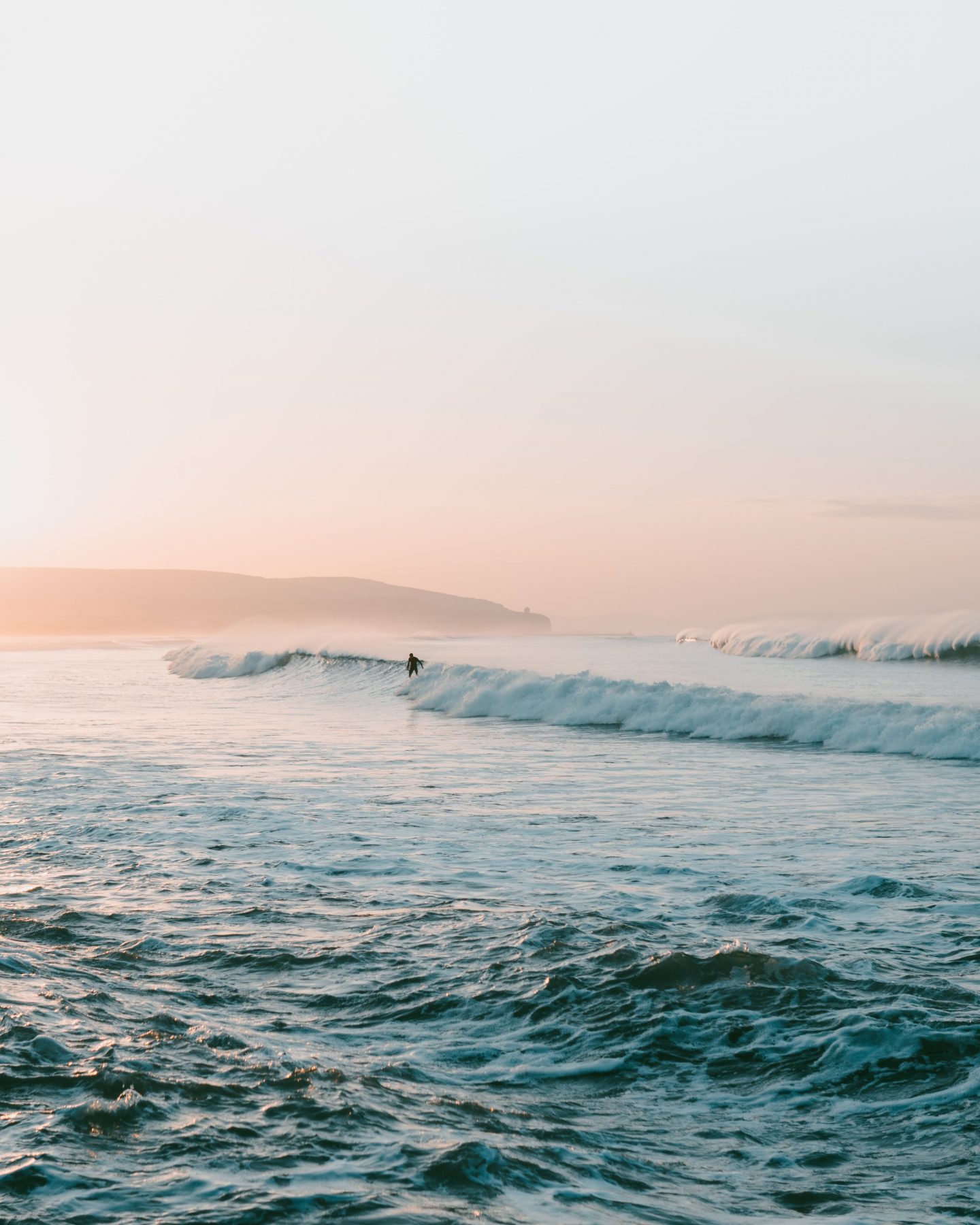 view of a surfer on the crest of a wave in the seat near Portstewart Strand