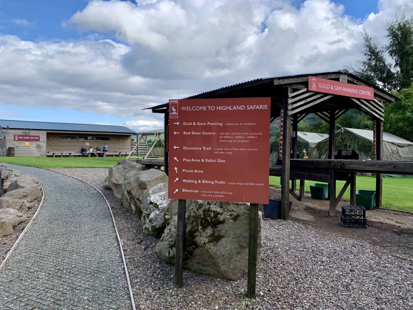 view of the entrance at highland safaris with red signage