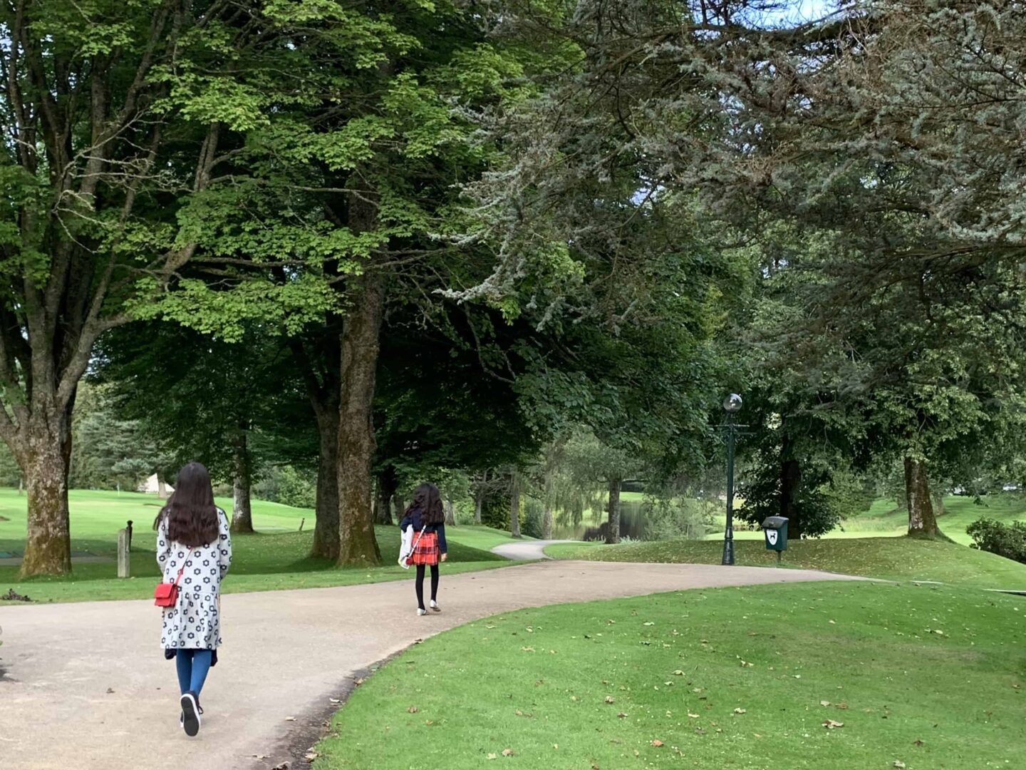 sima walking down the path in the gardens of the gleneagles hotel