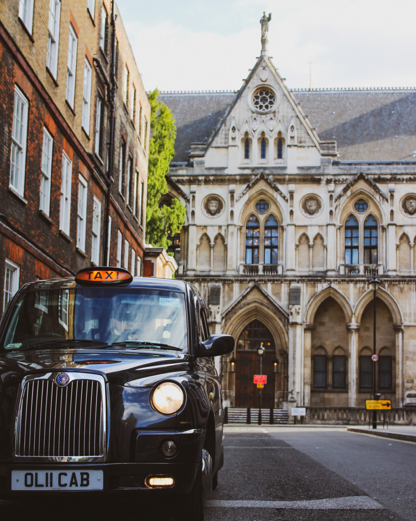 view of black cab registration OLII CAB in front of a church on the street of London