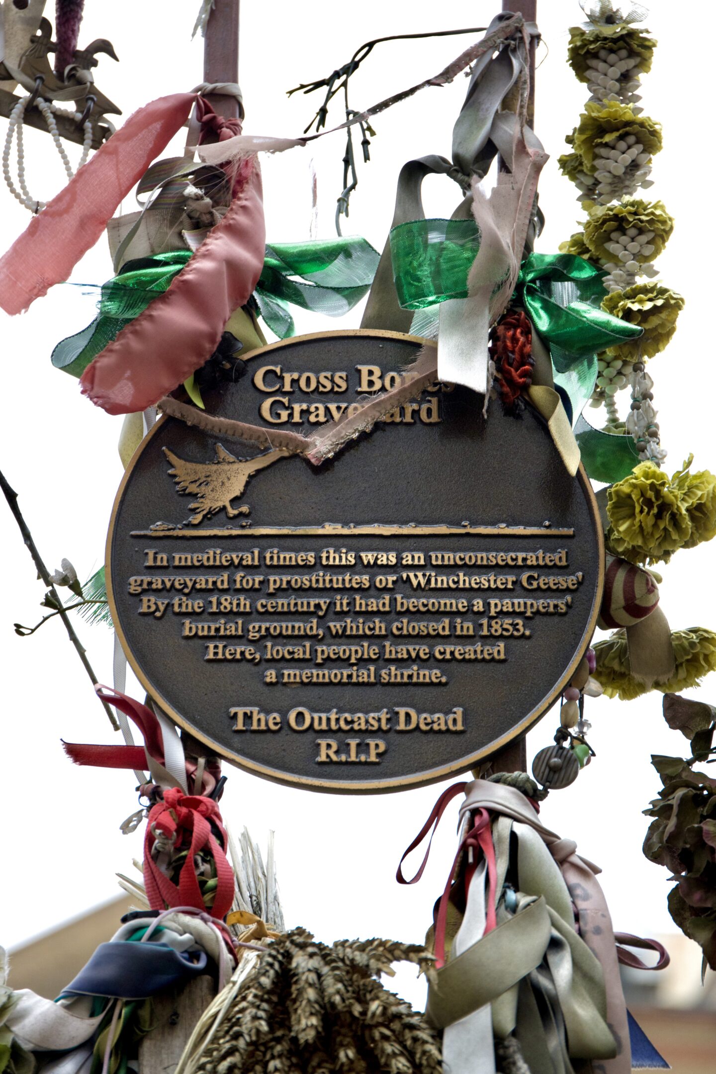 iron gates, ribbon and plaque from 'the outcast dead'