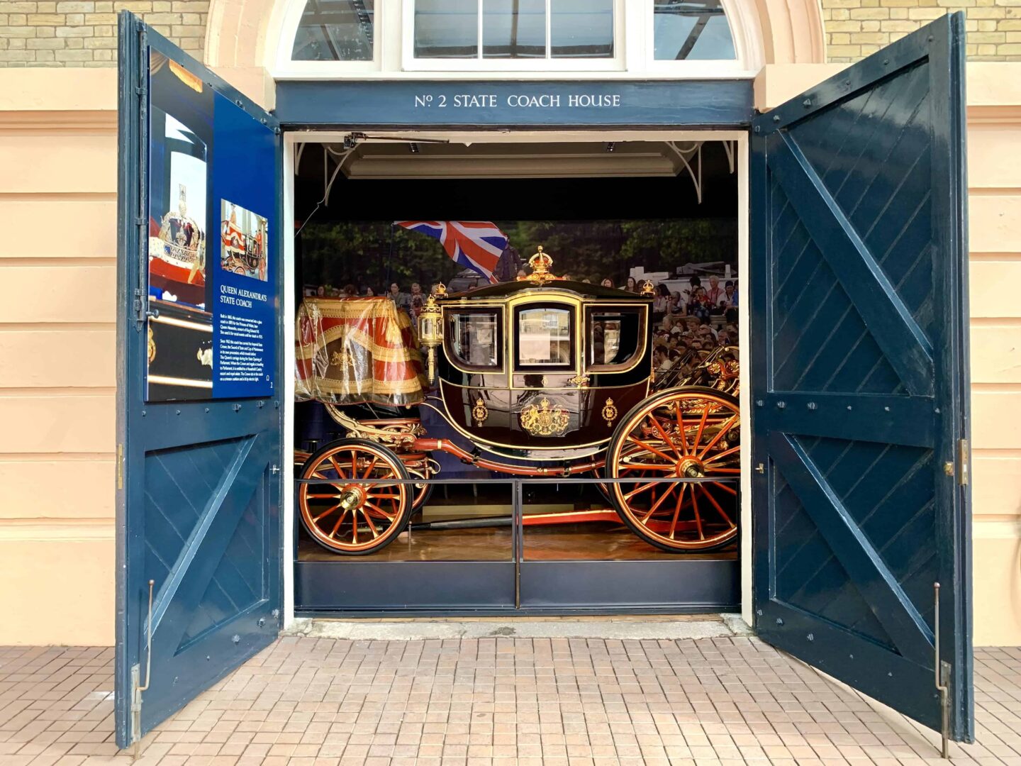 stationery black, gold and red STATE COACH pictured behind an open door or no 2 state coach house