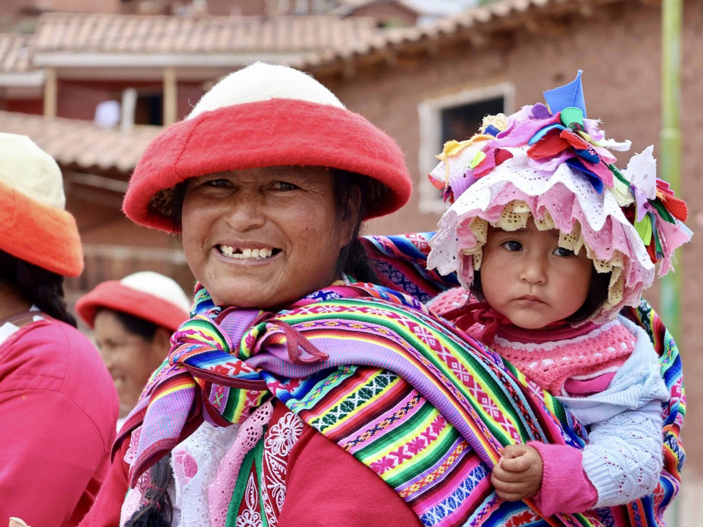Peruvian woman and baby in vibrant clothing